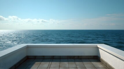 Obraz premium Panoramic coastal view of a calm blue ocean meeting a bright sky from an elevated balcony