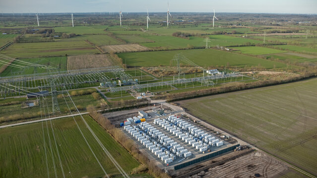 Grid-scale battery storage and substation in rural energy landscape. Large-scale battery energy storage system (BESS) installation within rural agricultural landscape. 