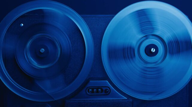 Tape audio music player, VHS studio magnetic tape, vintage retro spool reel to reel player and recorder, magnetic tape data storage close up, music studio. 