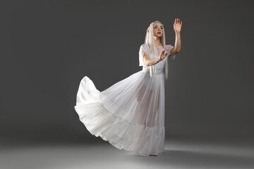 Naklejka premium Beautiful girl dressed as elf on grey background