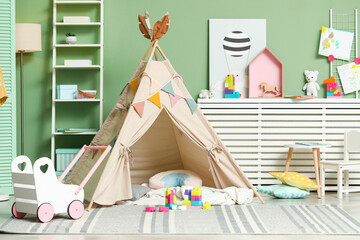 Cute wigwam and toys in stylish child's room © New Africa