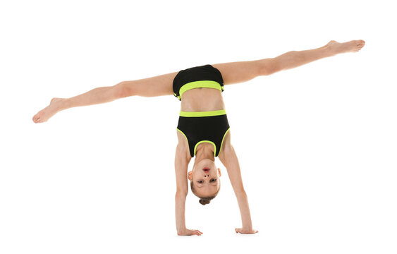 Cute little gymnast doing handstand on white background