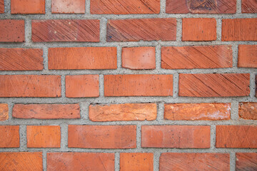 Fototapeta premium Red Brick Wall Texture With Mortar Joints And Weathered Surface Close-Up Pattern Background
