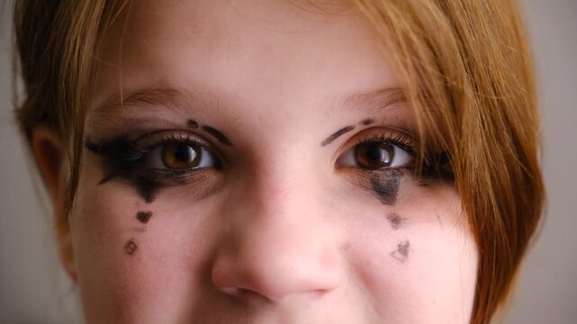 Close‑up shot captures a girl&rsquo;s mesmerizing eye, framed by dramatic stage makeup. Face paint. Performance on stage. Close‑up captures a girl&rsquo;s eye in the quiet moments before the curtain rises. 