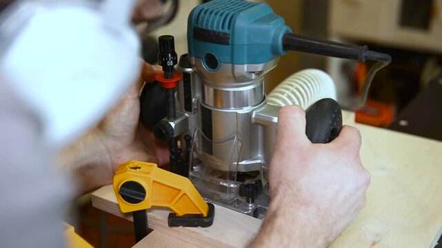 Woodwork workshop electric router tool shaping wooden plank with precision and care for detailed woodworking craftsmanship