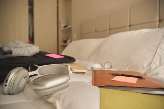 Bedroom bed converted into a temporary home office or study area with supplies