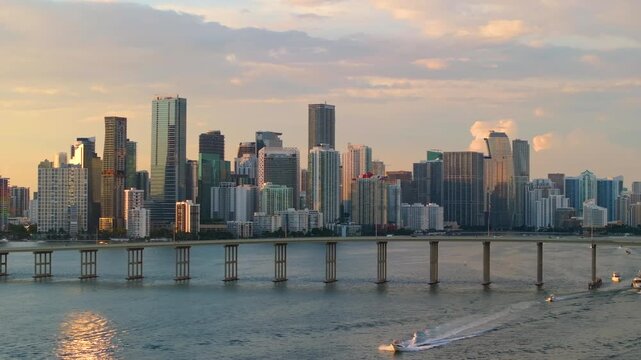 Downtown Brickell in Miami, Florida. William M Powell Bridge spanning across the bay with urban traffic and surrounding towers of glass and steel in vibrant financial district.