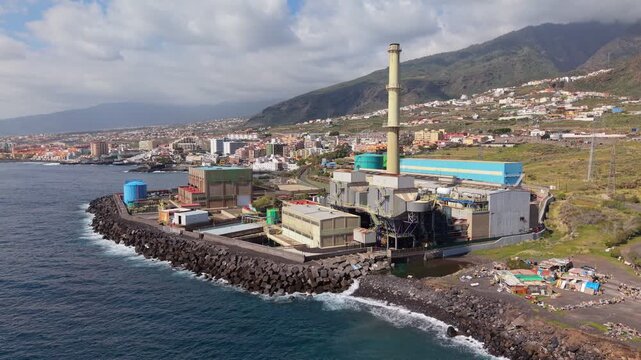 Aerial drone footage of the Central Termica Candelaria in Tenerife, Spain, showcasing a large coastal power station with industrial infrastructure and energy production facilities.