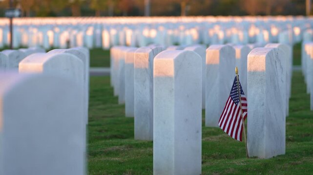 Sarasota National Cemetery with many white headstones and USA flag on green grass lawn. Memorial Day concept.