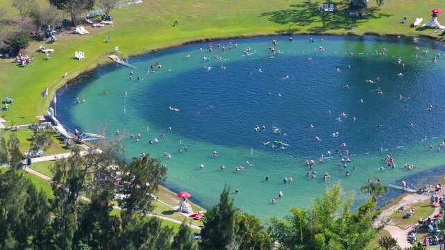 Scenic geothermal spring surrounded by nature, featuring saline water, swimmers floating peacefully, and a tranquil atmosphere connected to relaxation and healthy lifestyle.