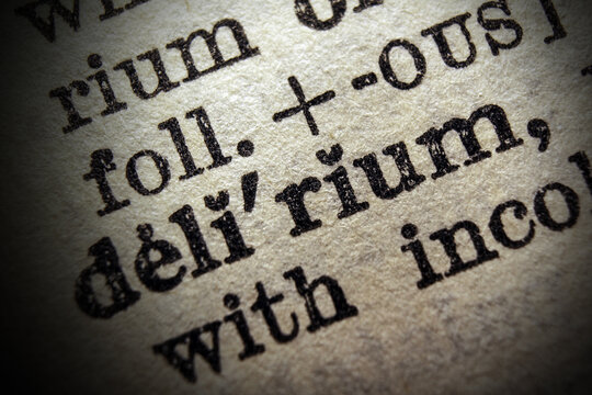 Word delirium printed on dictionary page, macro close up