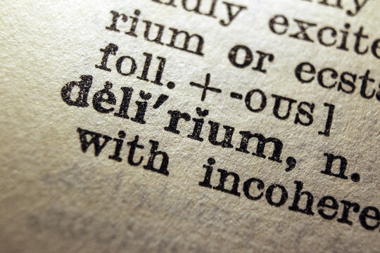 Word delirium printed on dictionary page, macro close up