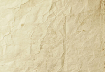 Fototapeta premium Crumpled beige paper texture background with wrinkles and creases, ideal for vintage design and aged look, stock photo for creative projects and commercial use.
