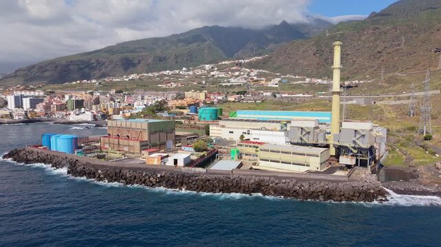 Aerial drone footage of the Central Termica Candelaria in Tenerife, Spain, showcasing a large coastal power station with industrial infrastructure and energy production facilities.