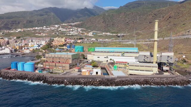 Aerial drone footage of the Central Termica Candelaria in Tenerife, Spain, showcasing a large coastal power station with industrial infrastructure and energy production facilities.