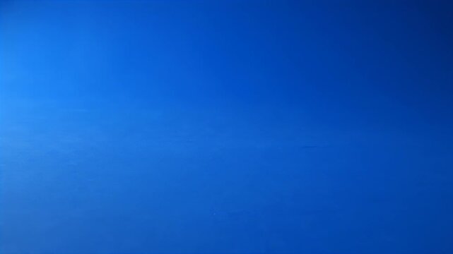 Studio Blue Backdrop with a Dark Curved Shadow on the Upper Left and a Flat Blue Floor