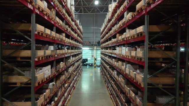Drone retreating along warehouse racks with stored goods