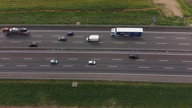 Aerial view of European logistics corridor on A50 ring road near Milan.