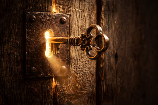Ornate Skeleton Key Inserted into an Antique Wooden Door