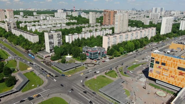Aerial backward rise over urban crossroads and traffic