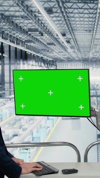 Vertical video Isolated screen display used by coworkers in microchips plant to monitor fabrication yield data. Chroma key monitor used by businesspeople visualizing semiconductors factory bottlenecks