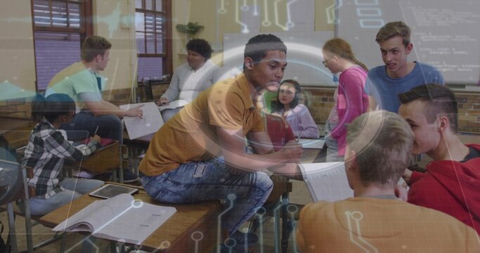 Leaning male teen in brown-orange tee holding notes, engaging peers in class with circuit overlay