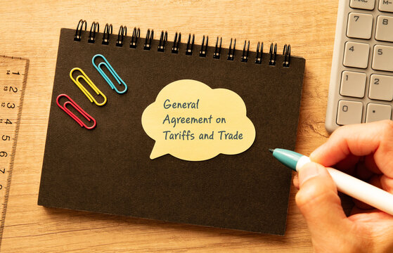 Professional visualization of General Agreement on Tariffs and Trade on speech bubble with calculator, pen, clips. Financial and economic strategic background.