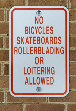 NO sign mounted on brick wall.