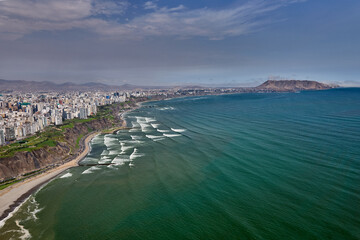 Obraz premium Aerial view of Miraflores and Costa Verde coastline in Lima, Peru, showcasing modern urban living along the Pacific Ocean with scenic cliffs, vibrant cityscape, and coastal landscapes. 
