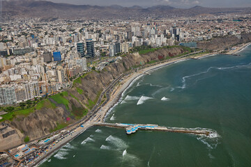 Obraz premium Aerial view of Miraflores and Costa Verde coastline in Lima, Peru, showcasing modern urban living along the Pacific Ocean with scenic cliffs, vibrant cityscape, and coastal landscapes. 