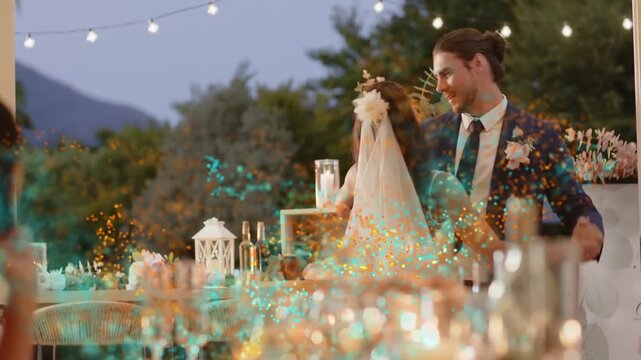 Groom leading bride from table, spinning dipping while teal sparks overlay couple for wedding