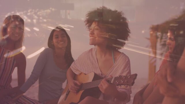 Female guitarist starting to strum, playing steady chords to set warm marketing mood, bokeh moving