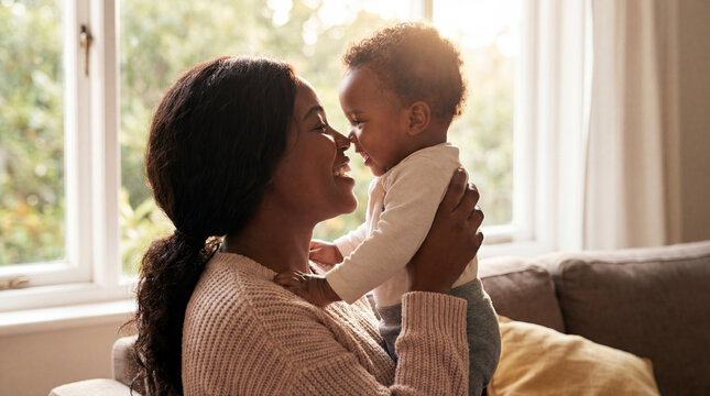 Mothers Day African American mom holding baby indoors eye contact showing love joy connection perfect for celebration greeting card magazine cover editorial commercial content materials