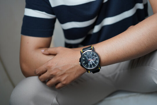 Casual Man Wearing Black Chronograph Watch with Modern Street Style Outfit