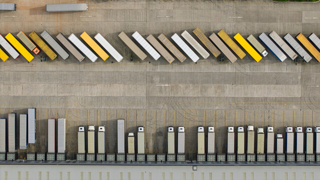 Aerial view of the Appleby Magna industrial park featuring rows of colorful semi-truck trailers parked at a logistics center Appleby Magna, England, United Kingdom.