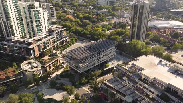 Aerial drone pullback view of OUM Wellness Center and city panorama San Pedro Garza Garcia Nuevo Leon Mexico