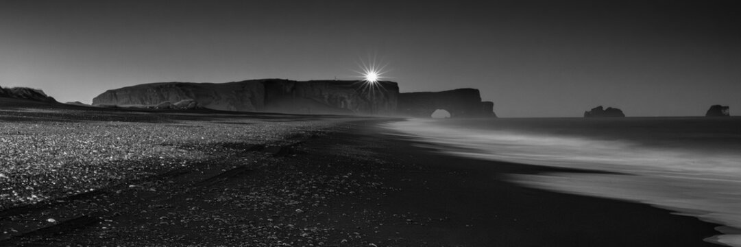 Black and White Panorama of Dyrholaey Arch at Sunset