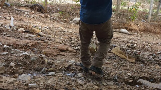 Man lifting concrete blocks for rural construction work