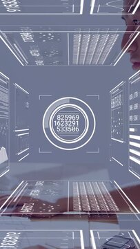 Typing Asian man responding to HUD appearing on laptop at desk, wearing light shirt, copy space