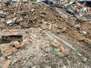 A large pile of rubble in a residential area, dismantling or demolishing old houses © Darya