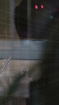 Vertical video: Man entering right, passing through glass, obscuring laptop while red LEDs glowing