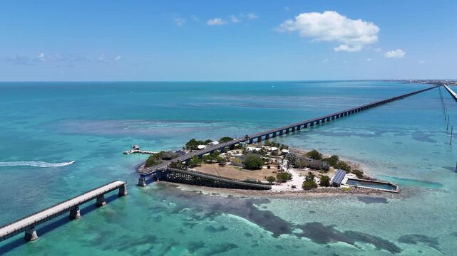 Boat arriving to historic Pigeon Key with the old Seven Mile Bridge near Marathon in the Florida Keys. 