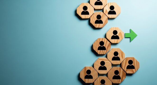Wooden tokens with human arranged in a pyramid shape with a green arrow pointing upward human pyramid
