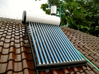 Close-up view of a solar water heater storage tank and piping system © Aji