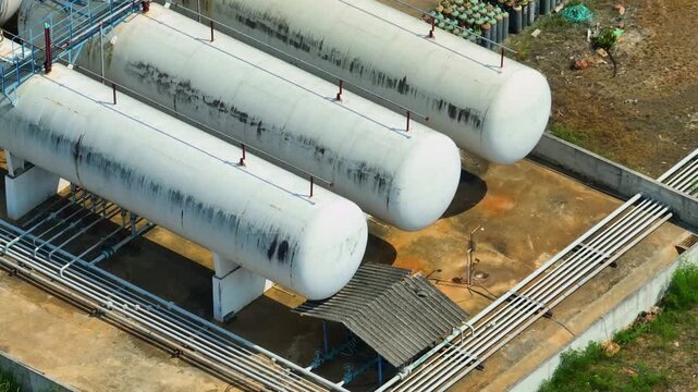 Aerial view of a gas processing facility with parallel storage vessels, emphasizing industrial engineering, energy management, and the importance of strategic fuel infrastructure in the current world.