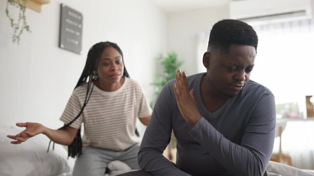 African American upset man and aggressive woman screaming at each other. 