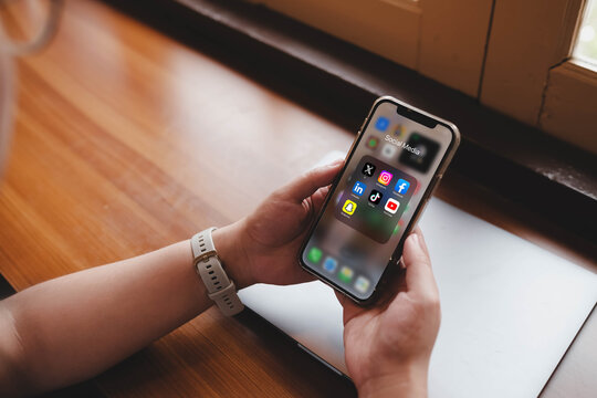 Bangkok, Thailand. April 16, 2026; A close-up shot of a person holding a smartphone that displays an open folder of popular social media applications like X, Instagram, Facebook, and TikTok.