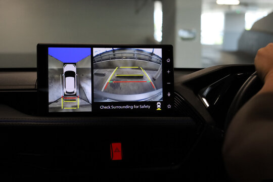 Car display showing rear and top view parking camera.