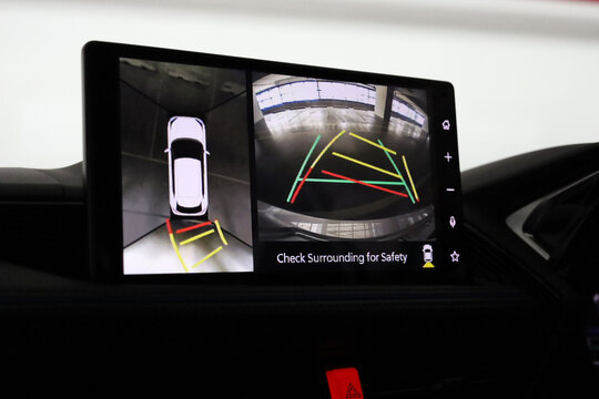 Car display showing rear and top view parking camera.