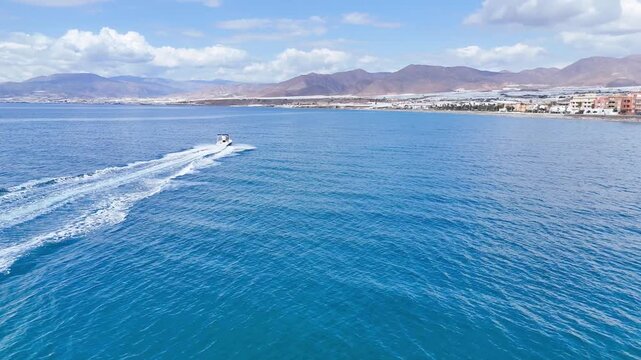 motorboat tracking coast navigation boat fast travel sea mountain drone landscape - Andalusia, Spain - 2025